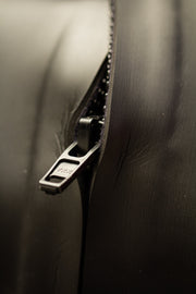 Close-up of the front zipper on the glideskin background in black.